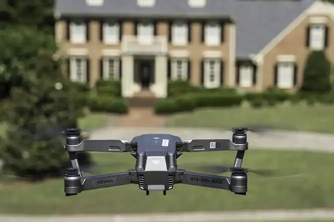 In flight photograph of a drone taking a picture. This in flight picture shows one of our drones at work. Our drone have both obstacle and collision avoidance.