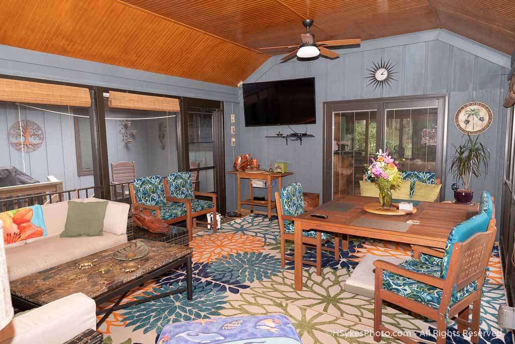 Enclosed porch with windows and wall mounted TV