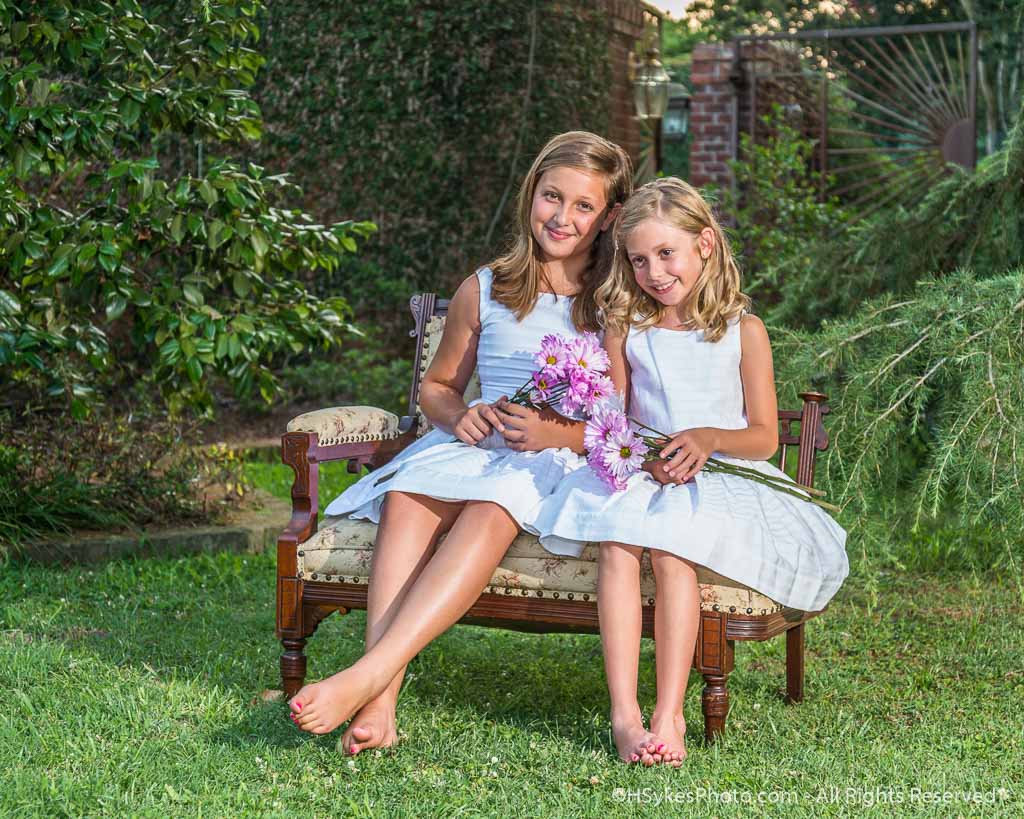 Picture of children sitting on a bench in a garden