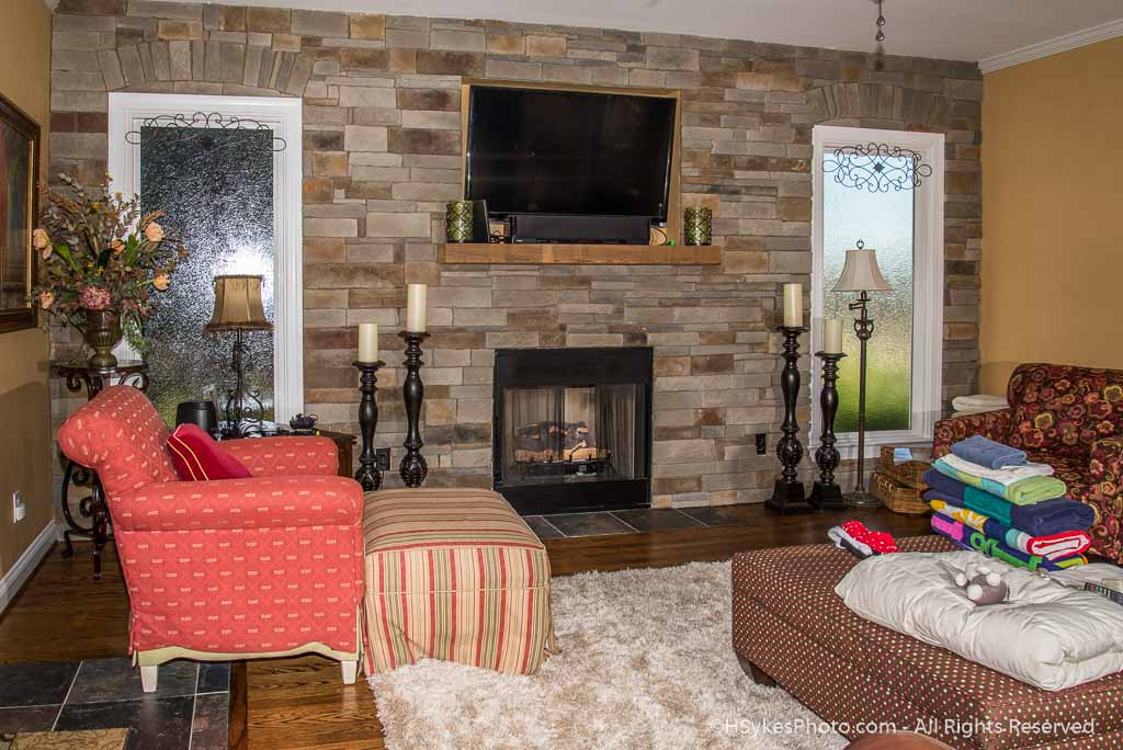 Family room with fireplace photographed by Howard Sykes