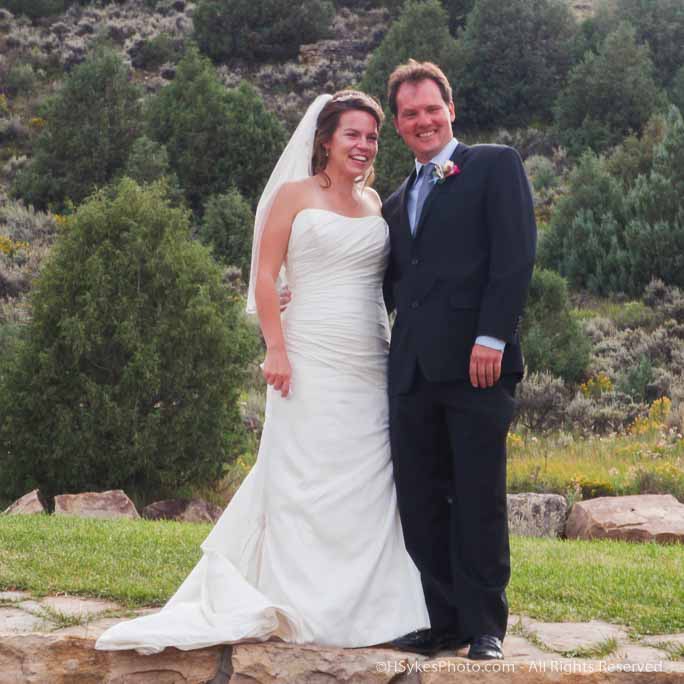 Portrait of a wedding couple on a rock wall