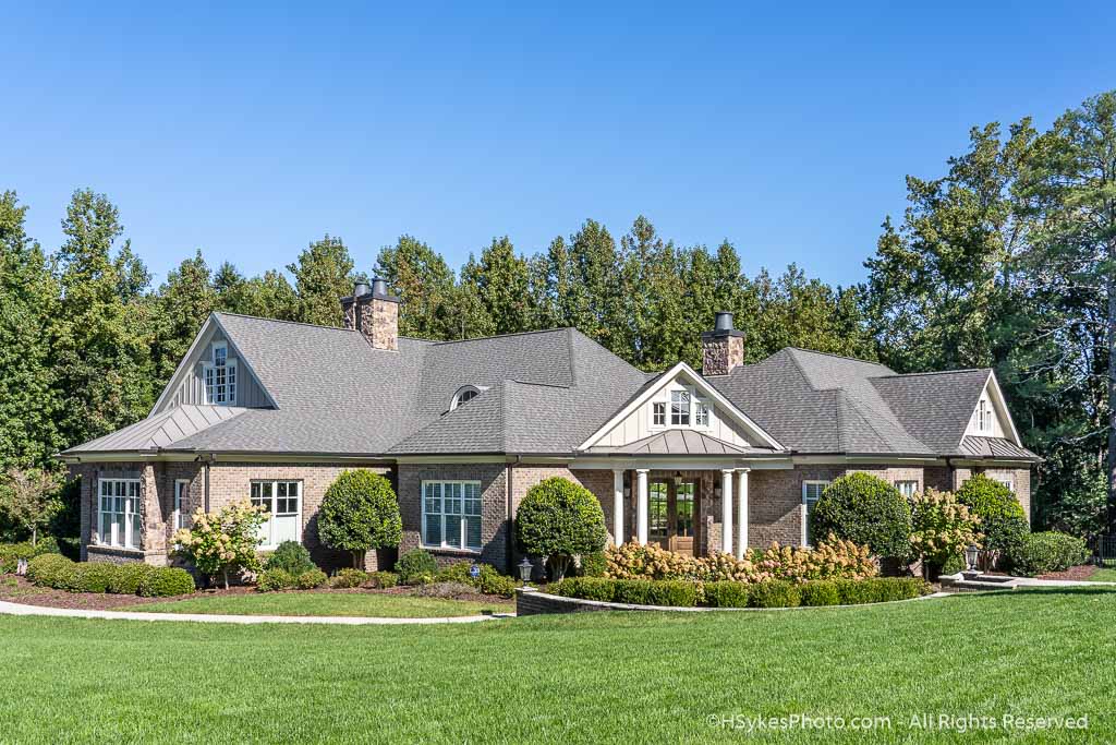 Three fireplace brick home with entry columns