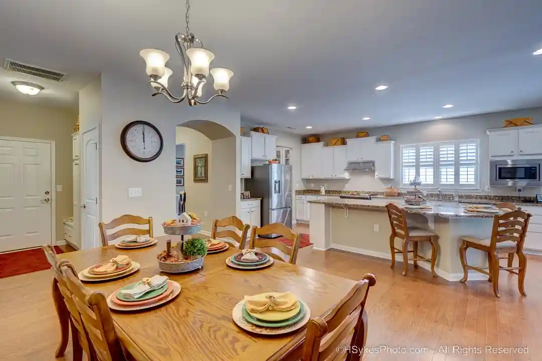 Dining room with kitchen in background