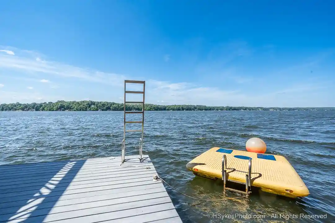 Swimming platform with boarding ladder along side the boat house